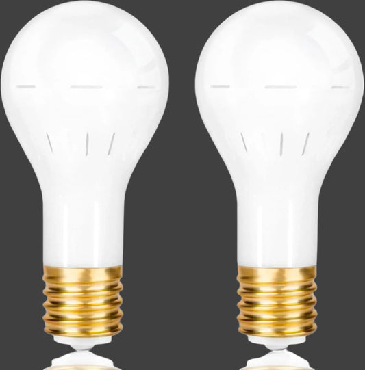 Two clear light bulbs with gold bases on a white background